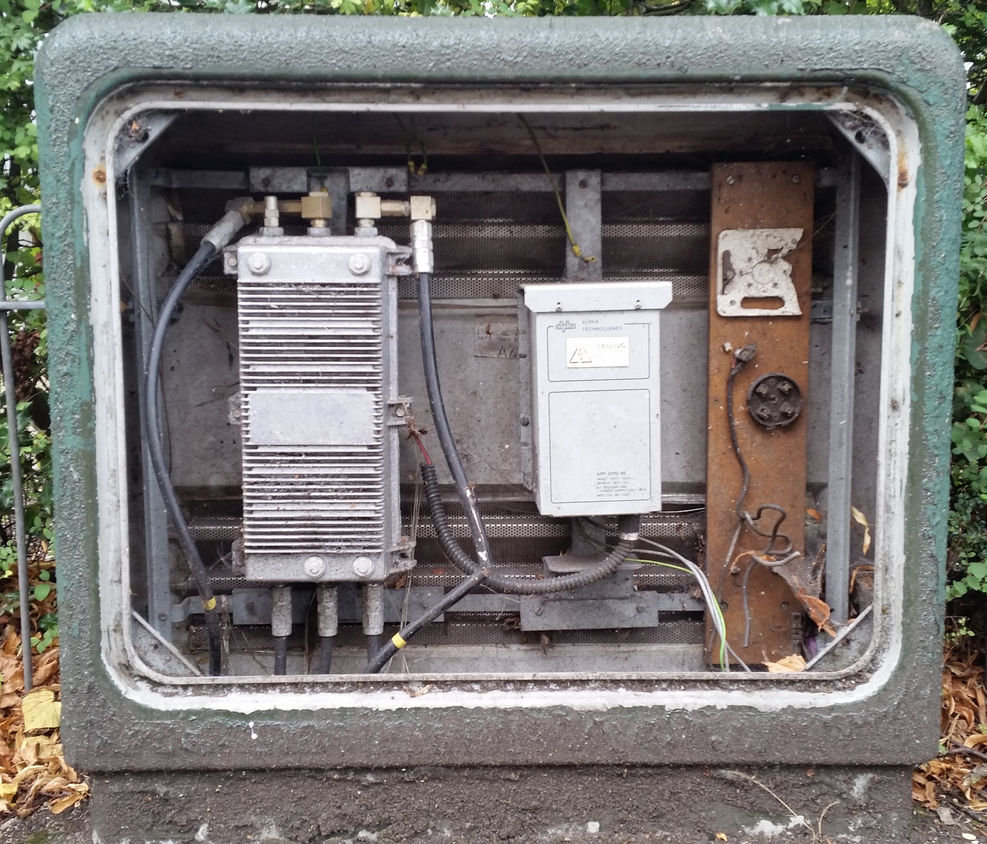 Green painted cabinet with a differnet design of ferroresonant transformer